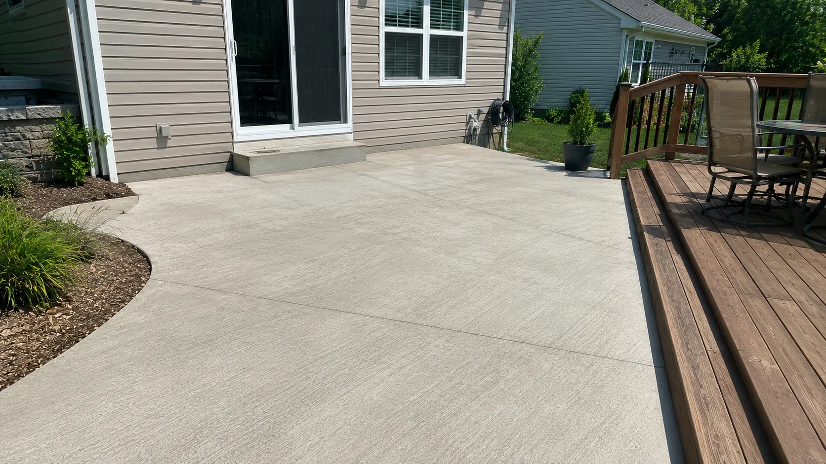 Side-by-side comparison of concrete, wood, and paver patio surfaces